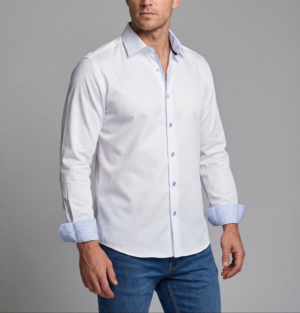 Model wearing the Gordon white button-up shirt with light blue contrast cuffs and blue jeans.